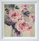 Framed artwork of pink flowers with a white border