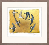 Framed artwork of birds flying against a gold background