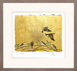 Framed artwork of birds on a branch with a gold background