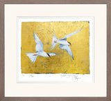 Framed artwork of two birds flying against a gold background