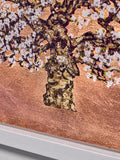Close-up of a tree with white flowers on a wooden surface