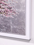 Framed artwork with pink floral design on a textured gray background