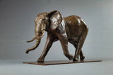Bronze elephant sculpture on a gray background