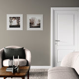 Living room with gray walls, a gray armchair, and a white door.