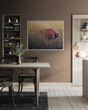 Dining room with a table, chairs, and a painting of a pheasant on the wall.
