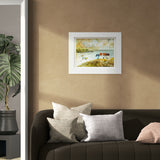 Framed artwork on a wall above a sofa with decorative pillows