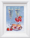 Framed artwork of two champagne flutes with strawberries and scones on a blue background.