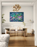 Modern dining room with a colorful abstract painting on the wall, wooden table, and chairs.