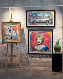 Artistic wall display with framed artworks on a textured brick wall.