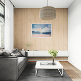 Modern living room with gray sofa, white coffee table, and wooden wall with framed artwork.