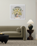 Living room with a beige sofa, framed artwork of a woman with flowers, and a lamp.