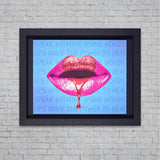 Framed artwork of pink lips with text on a brick wall background