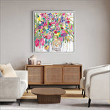 Living room with a floral painting on the wall, wooden cabinet, and white sofa.