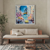 Colorful painting of a garden scene above a beige sofa in a living room.