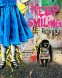 Collage with blue dress, monkey figure, and 'Keep Smiling' text on a textured background