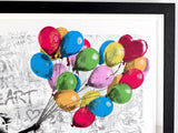 Colorful balloons on a textured background with a black frame.