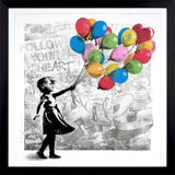 Framed artwork of a girl holding colorful balloons with motivational text on a white background.