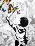 Stylized artwork of a child holding flowers and butterflies against a graffiti-covered wall.