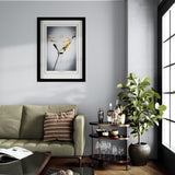 Living room with a gray sofa, framed picture, and a small round table with decorative items.