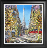 Framed artwork of a Parisian street with the Eiffel Tower in the background