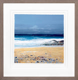 Framed photograph of a beach with blue sky and ocean.