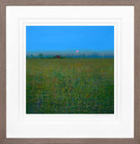 Framed artwork of a field with a blue sky and a red sun.
