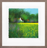 Framed artwork of a house in a field with yellow flowers and green trees.