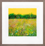 Framed artwork of a field with flowers and a yellow sky