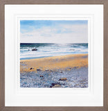 Framed artwork of a beach scene with waves and sky.