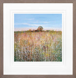 Framed artwork of a field with a wooden fence and trees under a blue sky.
