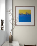 Framed artwork on a wall with a vase and branch decoration.