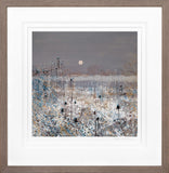 Framed artwork of a snowy landscape with a moonlit sky