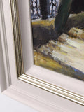 Close-up of a framed painting with a detailed view of the frame and part of the artwork.