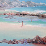 Beach scene with people walking along the shore and mountains in the background.