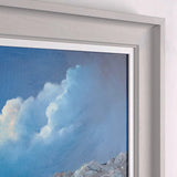 Framed artwork of a coastal scene with waves and rocks.