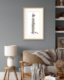 Living room with a framed artwork on the wall, a sofa with cushions, and a side table with a lamp.