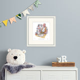 framed illustration of bfg and small girl sitting at a desk reading papers on a pale blue wall above a metal chest of drawers