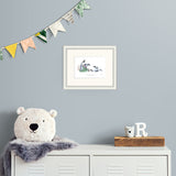 framed illustration on light grey wall above a metal cabinet.