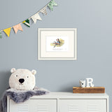 framed illustration on blue wall above a metal cabinet.