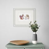 Framed artwork above a green cabinet with a wooden plate and white vase containing greenery.