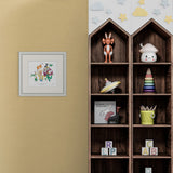 Framed illustration of a man and child with a large orange ticket, on a yellow wall next to shelves featuring childrens toys