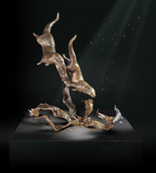 bronze sculpture of two diving otters.