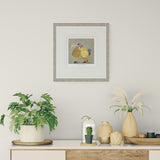 Decorative setup with plants, vases, and a framed picture on a wall.