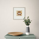 framed artwork above a green cabinet against a beige wall with a framed picture.
