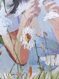 Close-up of a person's hands holding white flowers and grass in the background