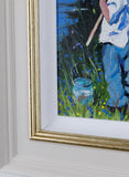 Framed painting of a person in a blue outfit with a white shirt, standing in grass with flowers.