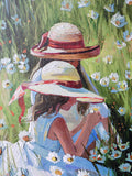 Two girls in sun hats sitting in a field of flowers