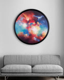Colourful abstract wall art above a gray sofa on a light gray wall