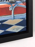Framed artwork of a cat on a chair with a checkered floor