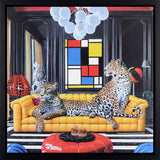 Two leopards on a yellow couch in a stylish room with colorful abstract art.